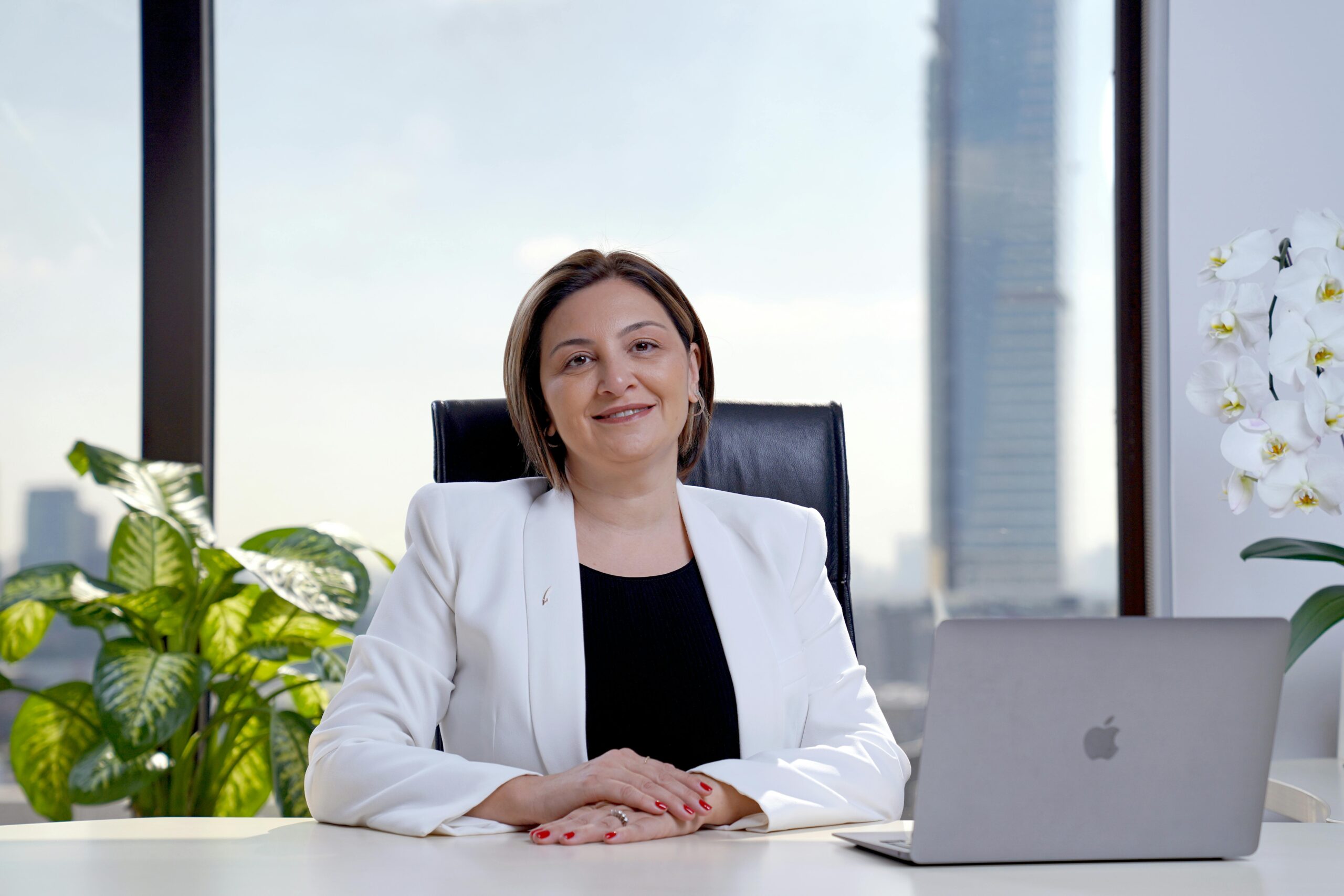 Businesswoman working on laptop in modern office.